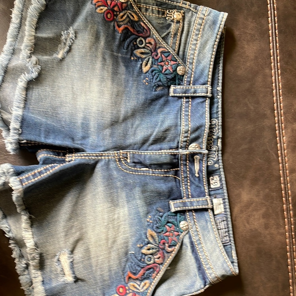 Miss me Jean shorts with embroidered design on pocket area.